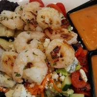Key West Chopped Salad · Hearts of romaine lettuce, spinach and mixed greens with chopped cucumbers, carrots, red oni...