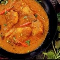 Crispy Fish Curry · Pan seared fish with onions carrots garlic and curry sauce topped with basil.