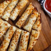 Cheesy Garlic Bread · Pizza dough topped with garlic and our three-cheese blend, baked and served with housemade m...