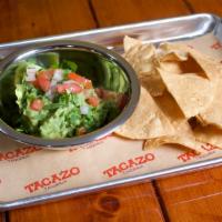 Guacamole · Mashed avocados, chopped onion, cilantro, tomatoes, and lime. Served with tortilla chips.