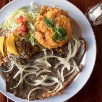 Bistec Encebollado · Thinly out steak cooked with onions, served with rice and beans.