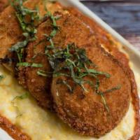 Famous Fried Green Tomatoes* · panko-crusted fried green tomatoes,  basil, roasted red pepper sauce, over heirloom grits wi...