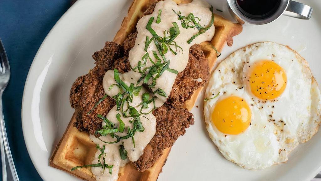 Country Style Fried Chicken* & Waffles · honey dusted fried chicken over buttermilk waffles, topped. with milk gravy & basil, with two fried eggs** on the side