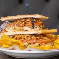 Sandwich De Pollo Especial · Special Grilled chicken sandwich topped with ham & cheese, onions, lettuce, tomatoes and jul...