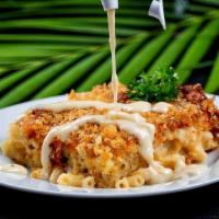 Smokey Baked Macaroni · Decadent, smoked gouda cheesy baked macaroni. Served with a side of gouda cheese sauce for a...