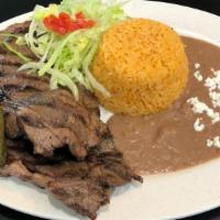 Grilled Steak Plate · Grilled steak with sauteed peppers and onions. Served with rice, beans, and salad, 5 corn to...