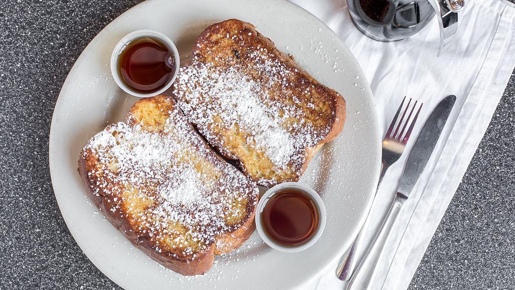 Two Slices French Toast · Thick-sliced challah bread French toast dusted with powdered sugar.