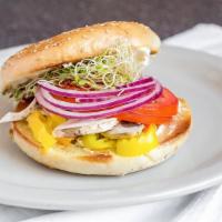Grilled Veggie Bagel · A grilled bagel filled with cream cheese, fresh mushrooms, onions, tomato, sunflower sprouts...