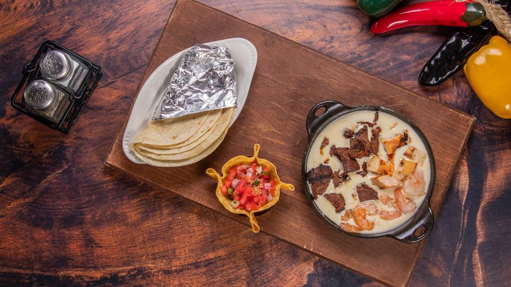 Zama'S Texas Dip · Large bowl of our delicious, mouthwatering melted cheese with grilled steak, chicken, and shrimp.