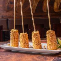 Mexican Street Corn · Corn roasted over an open grill and coated with salt, chile powder, butter, cotija cheese, l...