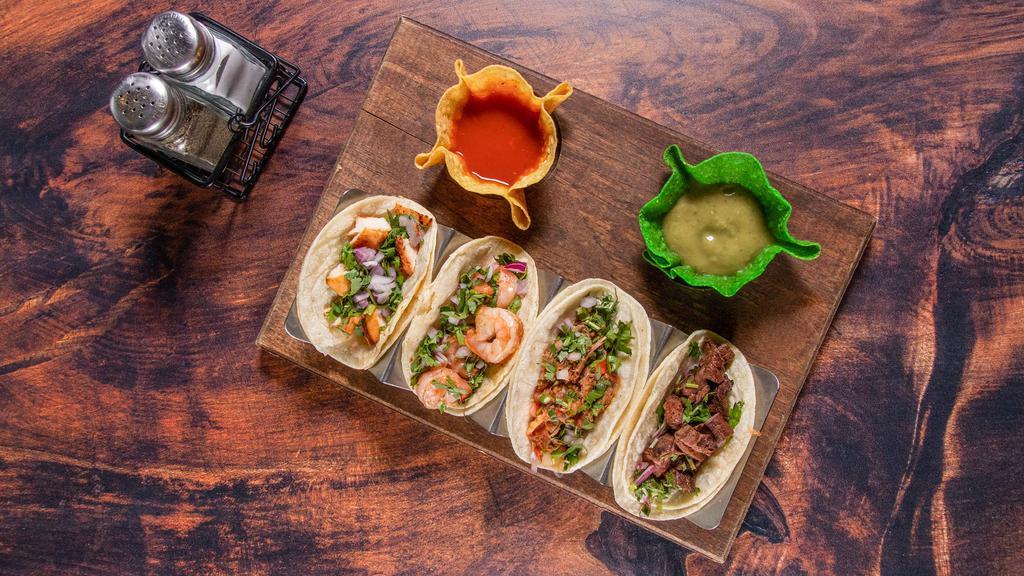 Zama'S Selection Tacos · Selection of four tacos steak, chicken, shrimp, and brisket. Served with avocado slices, raw onions, and cilantro. Accompanied with sauces and with three tacos.