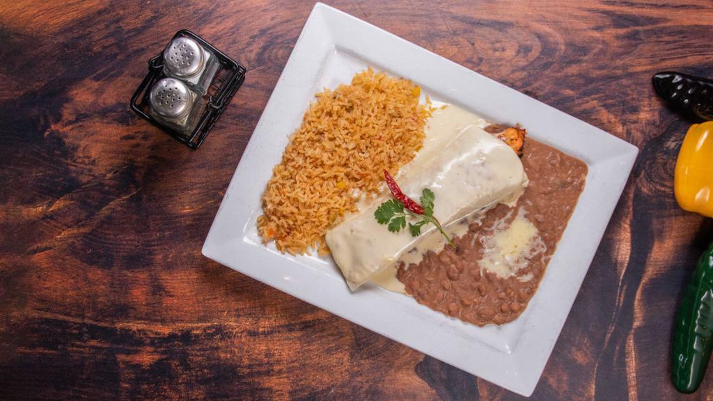 Zama Grill Burrito · Our mouthwatering grilled steak or chicken rolled in a flour tortilla and covered with our tasty cheese dip, with or without jalapeños. Served with Mexican rice and Mexi beans.