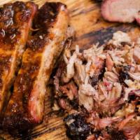 Pit Master Trio · 3 meats (ribs, brisket, and pulled pork) with your choice of 2 sides and one brown butter ho...