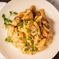Cajun Alfredo · Fettuccine, Cajun cream sauce, chicken, sausage, shrimp, Parmesan, and parsley.