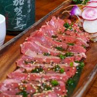 Beef Tataki · Lightly seared meat served with ponzu sauce and scallions.