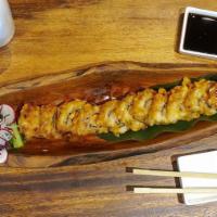 Tempura Bagel Roll · Salmon, cream cheese and scallions roll deep fried served with eel sauce.