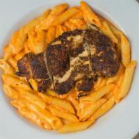 Blackened Chicken Pasta · Penne pasta tossed with our home-made red pepper cream and topped with blackened chicken.