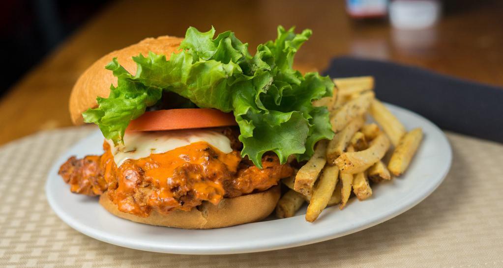 Buffalo Chicken Sandwich · Spicy, fried chicken breast coated with our medium wing sauce, covered in melted pepper jack cheese, served on a toasted brioche bun with a side of our house-made bleu cheese sauce for dipping.