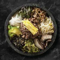 Dolsot Bibimbap - Stone Pot · Steamed rice in hot stone pot with vegetables, beef and topped with a fried egg.