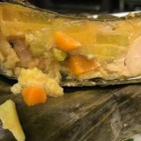 Tamal Tolimense (Colombia) · Steamed cornmeal dough with minced and seasoned chicken and pork wrapped in a banana leaf.