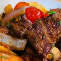 Lomo  Saltado (Peru) · Marinated beef  strips stir with onions, tomatoes, parsley, fries soy sauce mixture served w...