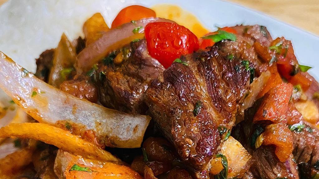 Lomo  Saltado (Peru) · Marinated beef  strips stir with onions, tomatoes, parsley, fries soy sauce mixture served with White rice.
