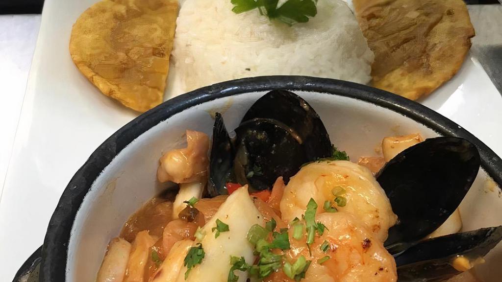 Mariscos O Camarones Al Ajillo (Chile) · Mixed seafood  or Shrimp sautéed in “hogao” garlic creole broth served with white rice and crispy patacon.