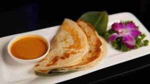 Roti Canai · Flatbread served with a side of our signature curry sauce. Spicy.