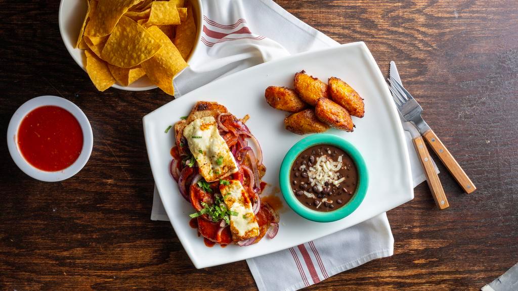 Pork Chops Plate · Three 4 oz grilled pork chops topped with grilled red onions, ranchero sauce, and roasted queso fresco. Served with black beans and sweet plantains.