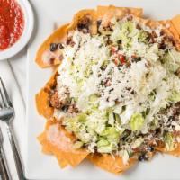 Supreme Nachos · House-made corn chips with queso, beans, lettuce, pico de gallo, sour cream, and cheese.