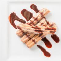 Churros · Fried dough pastry with caramel filling dusted with cinnamon sugar and served with 2 oz. of ...