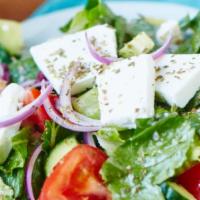 Greek Salad · Fresh tomato, feta cheese, cucumbers, onions, oregano, peppers and virgin olive oil.