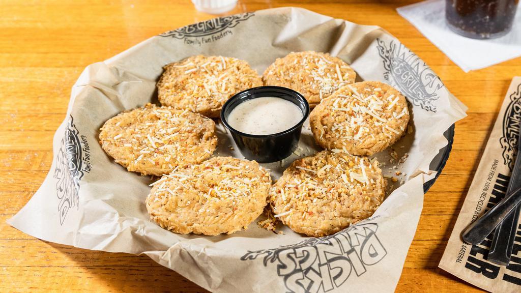 Fried Green Tomatoes · Fresh green tomatoes. Breaded, deep fried & topped with Parmesan cheese, garlic pepper flakes & served with Cajun ranch dressing.