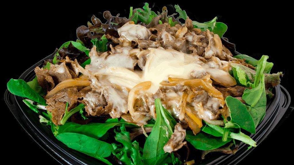 Steak Philly Salad · USDA Choice Grilled Steak, Grilled Onions, & Swiss American Cheese on Mixed Greens.