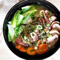 Japanese Miso Ramen · Soft Ramen noodles, carrots, mushrooms, Asian greens, seaweeds and scallions in hearty regul...
