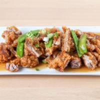 Pollo Chi Jau Kay · Crispy chicken fillets, snow peas and oyster sauce.