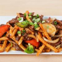 Lomo Saltado · Signature Peruvian stir-fried beef with French fries, onions and tomatoes cooked in a vinega...