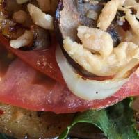 Veggie Burger · Two thinly slices of marinated Eggplant pan seared with Hummus and topped with Onions, Bell ...