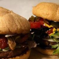 Veggie Vixen Burger · Two thinly sliced marinated eggplant pan seared with hummus topped with onions, bell peppers...