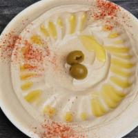 Hummus · A puree of chickpeas, sesame, lemon juice, salt, and garlic topped with paprika and olive oi...