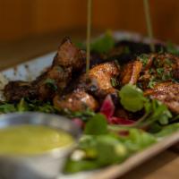 Chicken Adobo Thighs · Chicken thighs rubbed in our special ancho chili spice served with watercress and pickled on...