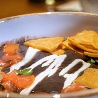 Black Bean Soup · Black Bean pure topped with sour cream, pico de gallo, and cripsy tortilla chips. 
(Vegan fr...