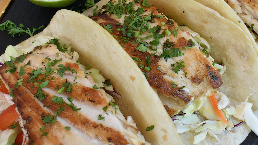 Fish Tacos · Grilled catch of the day, slaw, chipotle aioli.