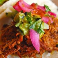 Pork Tacos · Pulled pork roasted with achiote, pickled red onions and guacamole.
