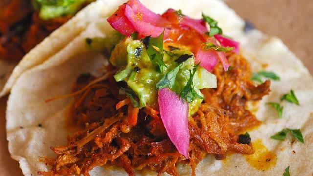 Pork Tacos · Pulled pork roasted with achiote, pickled red onions and guacamole.