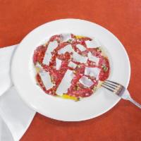 Carpaccio Di Manzo · Thin slices of raw filet mignon topped w/minced onions, capers, Slivers of Parmesan cheese &...