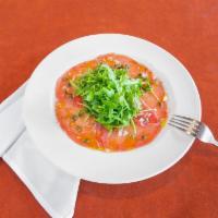 Carpaccio Di Tonno · Thin slices of raw tuna served w/minced onions, capers, lemon & w/extra virgin olive oil Dec...