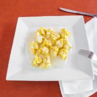 Fiocchi Di Pera · Filled pasta purses with pear & cheese served in an Alfredo sauce