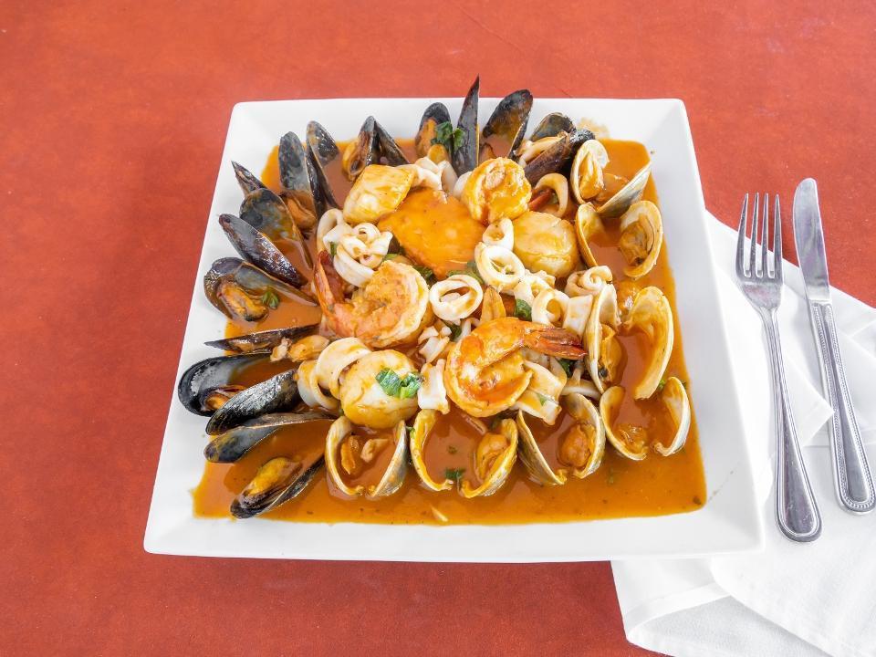 Zuppa Di Pesce · Salmon, over-sized shrimp, calamari, scallops, mussels, little neck clams Sautéed in a tomato sauce OR in a white wine and garlic sauce over linguine
