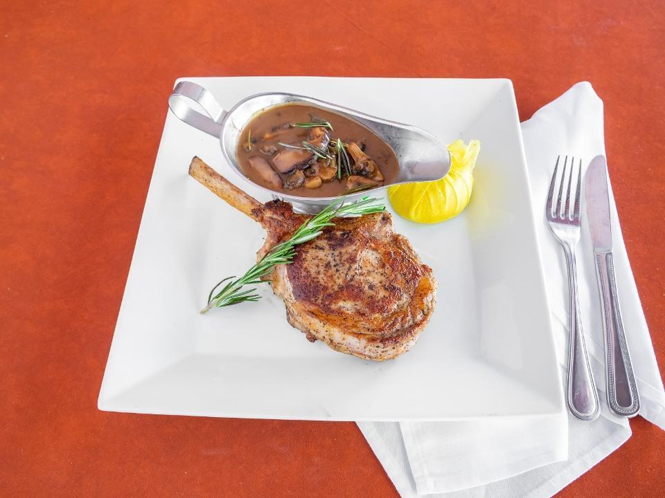 Veal Chop 14Oz · Roasted 14 oz veal chop seasoned with shallots & flambéed In a brandy & Marsala wine sauce with Portobello mushrooms